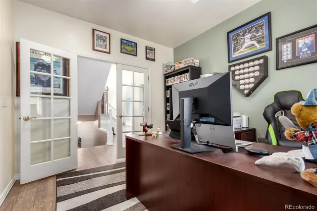a living room with furniture a flat screen tv and a floor to ceiling window