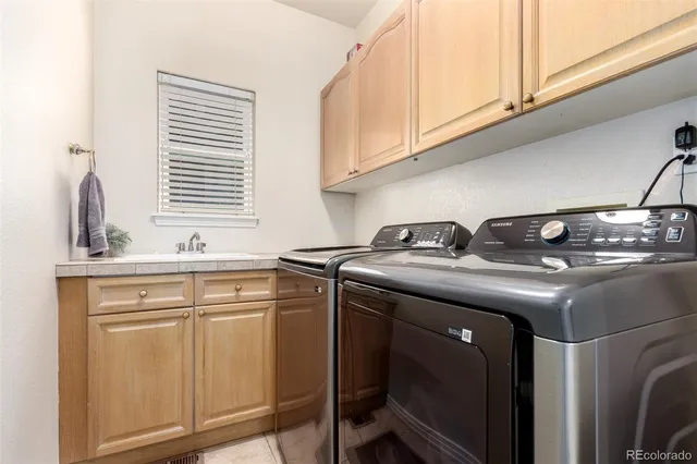 a kitchen with a sink cabinets and appliances