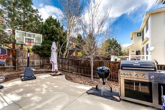 a view of a chairs and tables in the back yard of the house