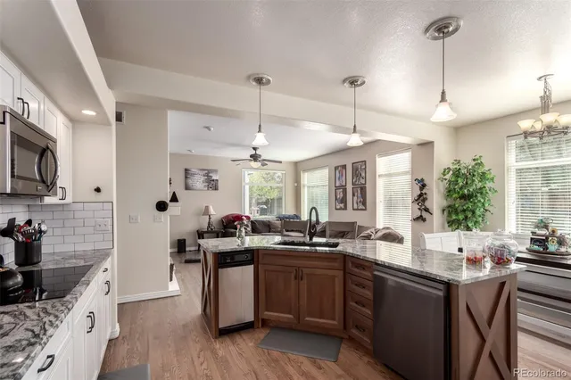 a kitchen with stainless steel appliances a sink stove and cabinets