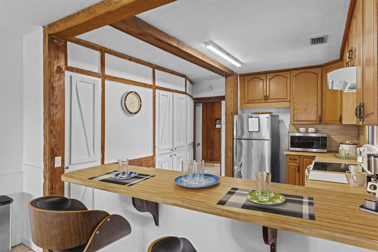 14601 Orange Avenue Fort Pierce, FL 34945 - Photo 12 of 37 a kitchen with stainless steel appliances granite countertop a sink and cabinets