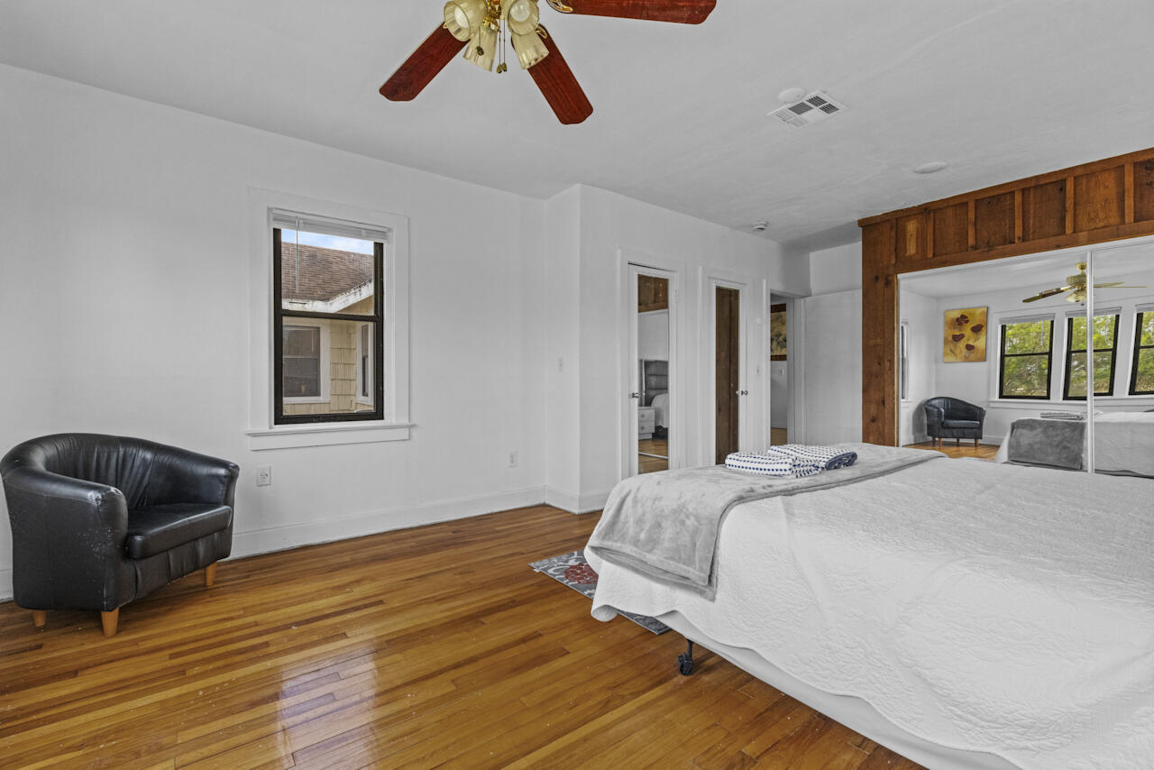 14601 Orange Avenue Fort Pierce, FL 34945 - Photo 17 of 37 a bedroom with a bed and wooden floor