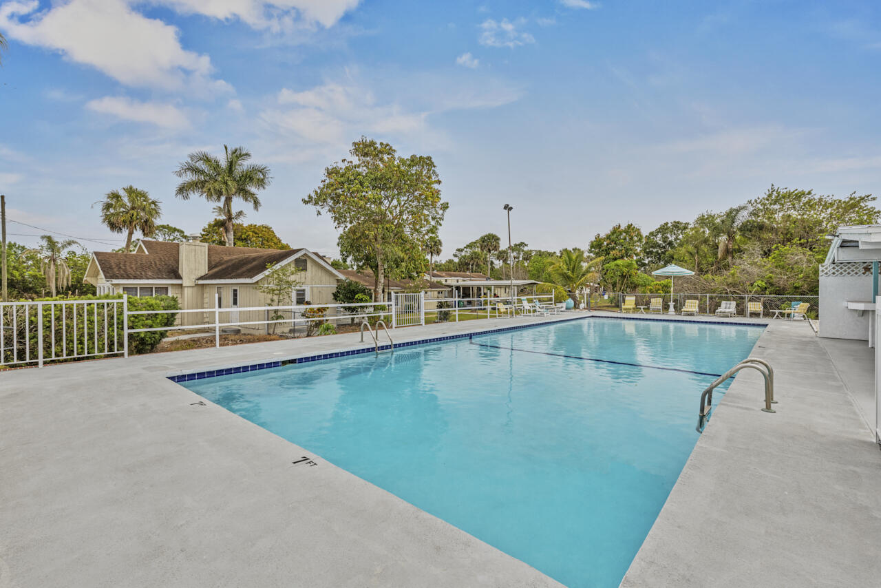 14601 Orange Avenue Fort Pierce, FL 34945 - Photo 23 of 37 a view of a swimming pool with a yard