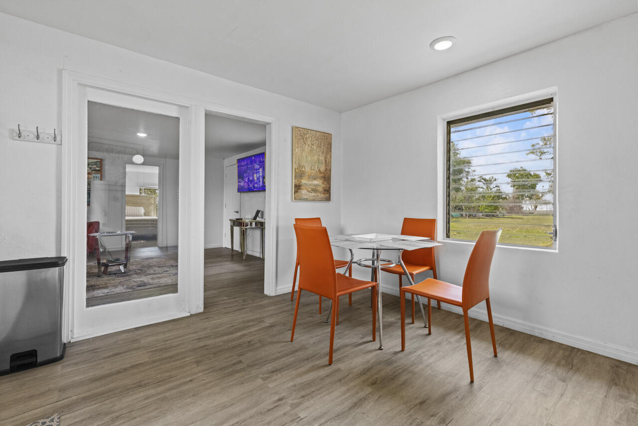 14601 Orange Avenue Fort Pierce, FL 34945 - Photo 35 of 37 a dining room with furniture and wooden floor