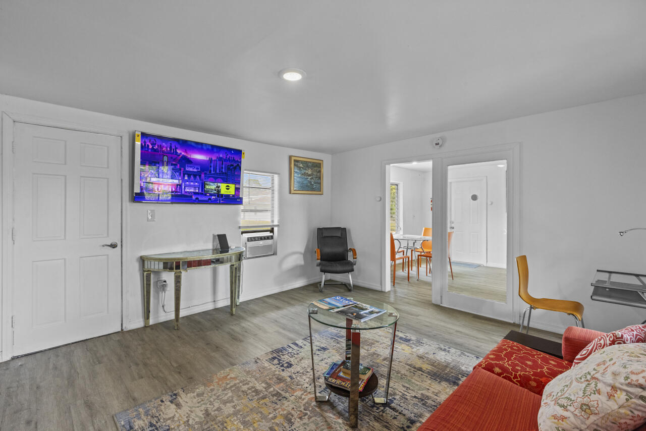 14601 Orange Avenue Fort Pierce, FL 34945 - Photo 36 of 37 a living room with furniture a flat screen tv and kitchen view