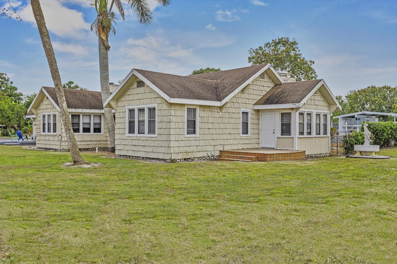 14601 Orange Avenue Fort Pierce, FL 34945 - Photo 5 of 37 a front view of a house with a garden