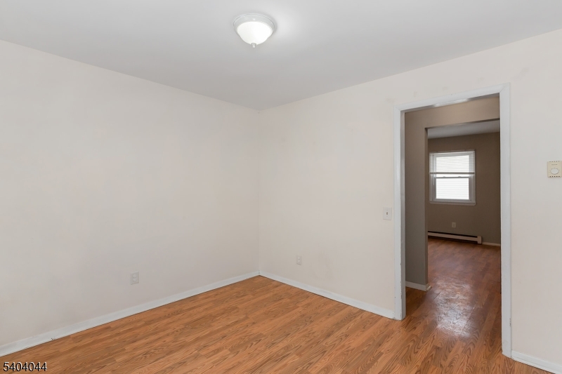 223 Liberty Street, Unit 2 Boonton, NJ 07005 - Photo 11 of 22 a view of empty room with wooden floor and fan