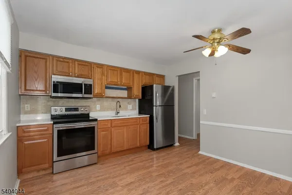 a kitchen with stainless steel appliances a stove microwave and refrigerator