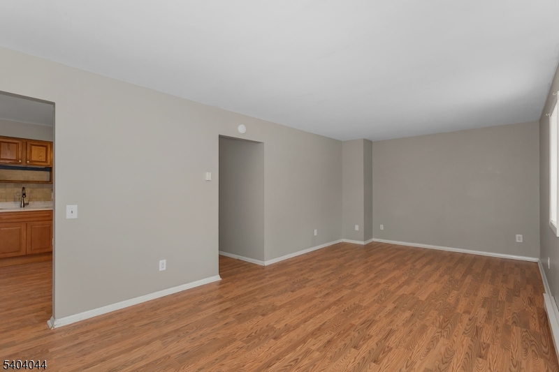 223 Liberty Street, Unit 2 Boonton, NJ 07005 - Photo 8 of 22 a view of an empty room with wooden floor