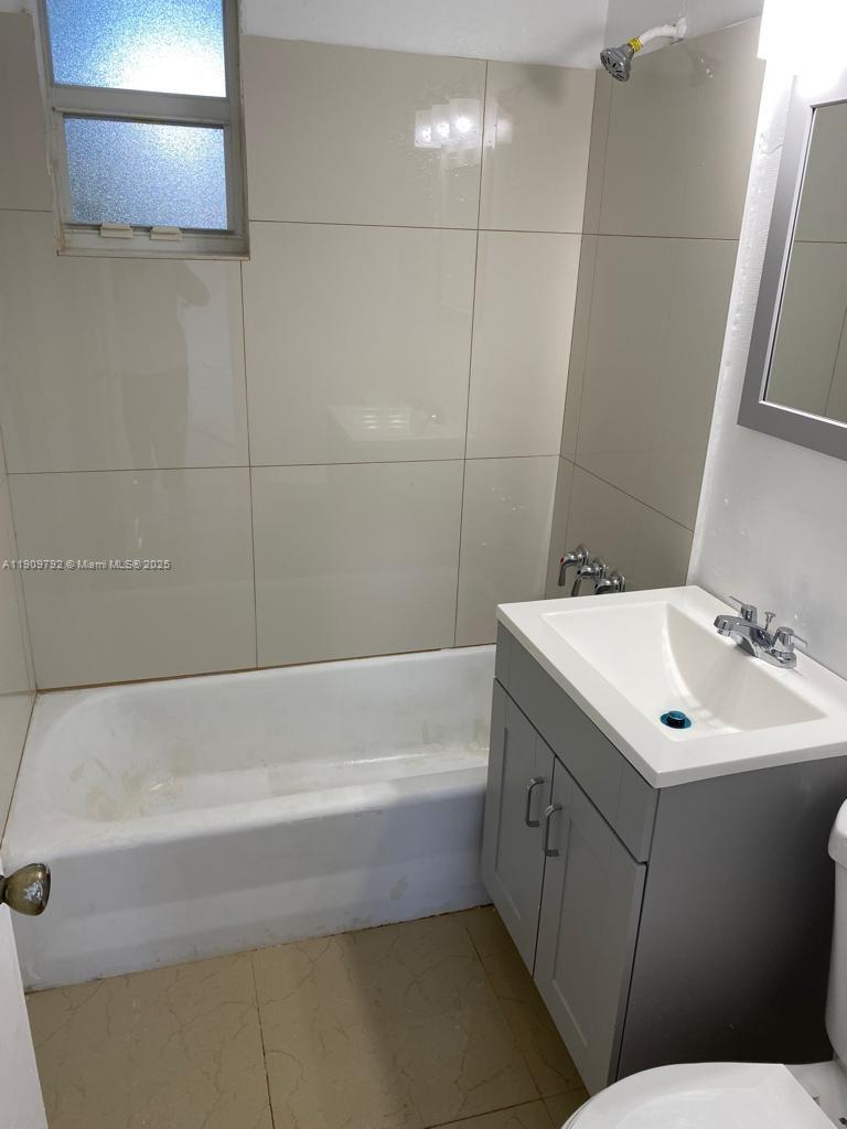 2181 Northwest 91st Street Miami, FL 33147 - Photo 11 of 14 a bathroom with a sink and a bathtub
