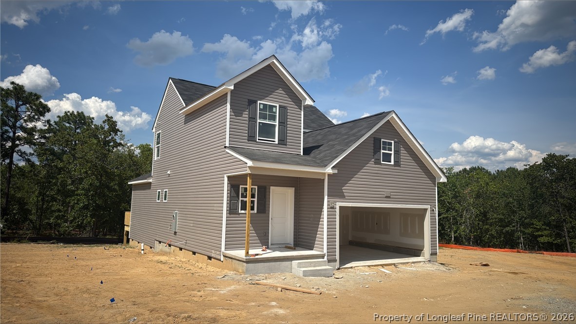 113 Colorado Court Spring Lake, NC 28390 - Photo 2 of 5 a front view of a house with a yard and garage