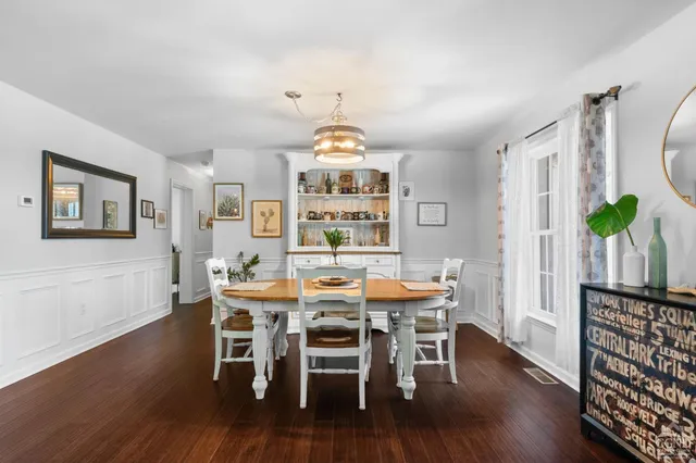 a view of a dining room with furniture wooden floor and chandelier