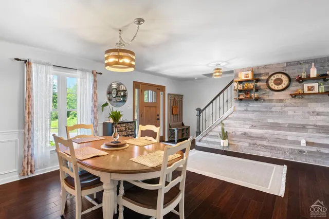 a view of a dining room with furniture window and wooden floor