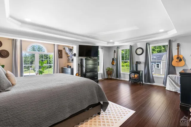 a spacious bedroom with a bed and a large window