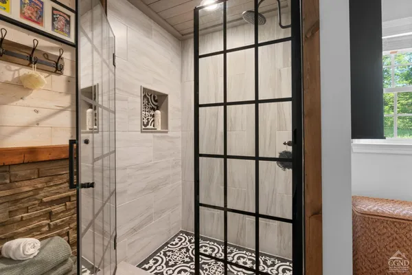 a bathroom with a granite countertop tub a double vanity sink and a large mirror