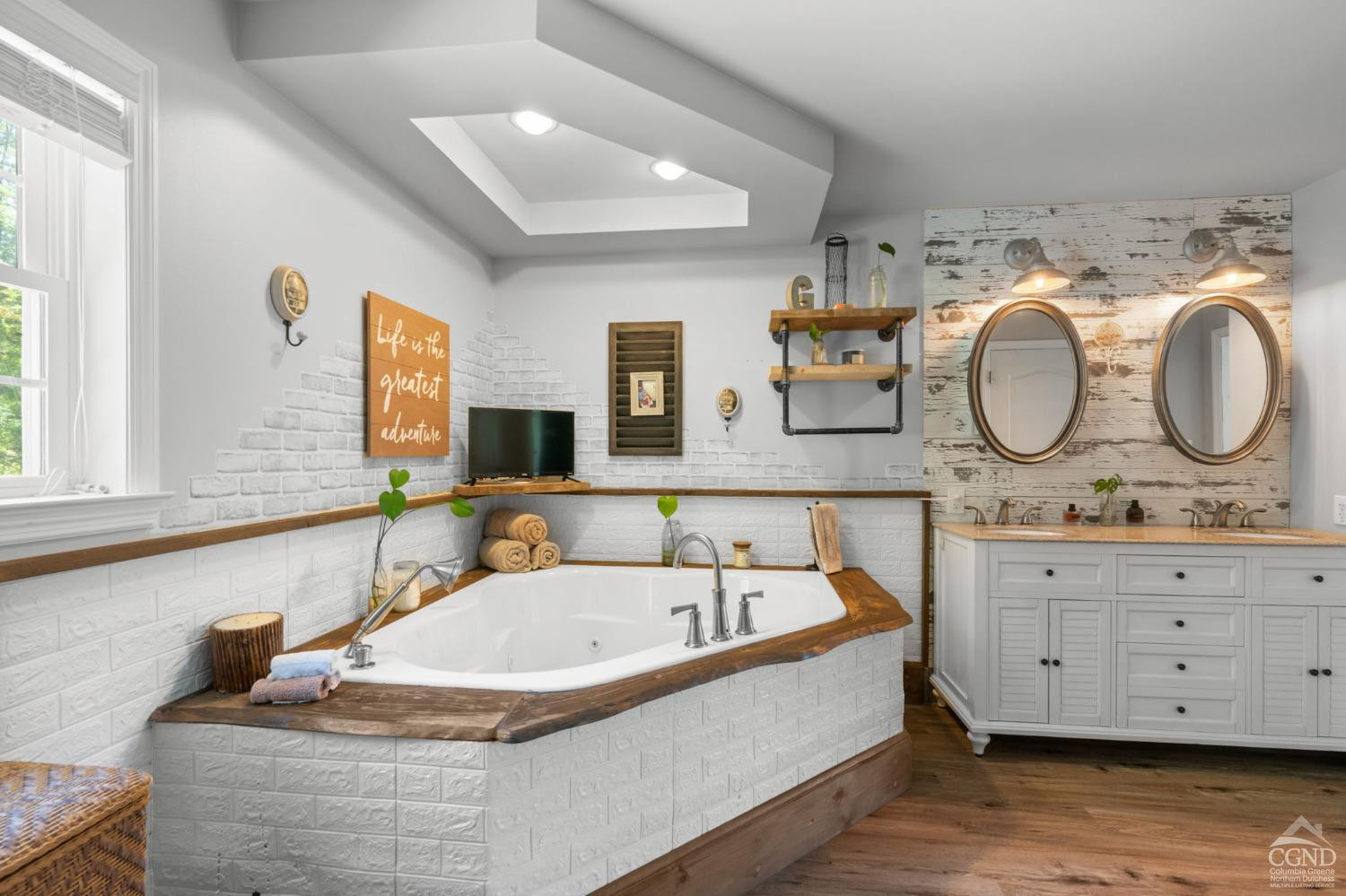 174 Grove School Road Catskill, NY 12414 - Photo 20 of 52 a bathroom with a granite countertop tub a double vanity sink and a large mirror
