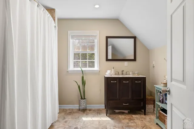 a bedroom with a bed dresser and a window