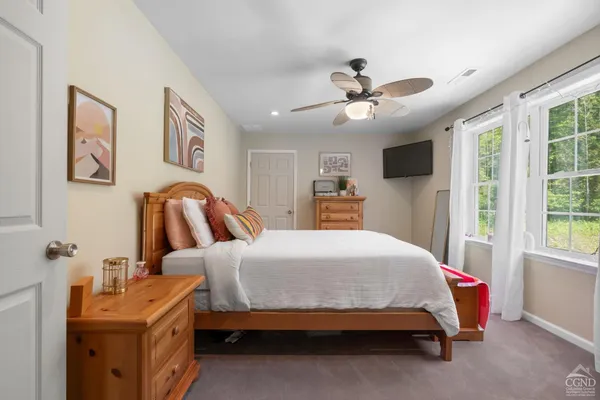 a bedroom with a large bed and a window