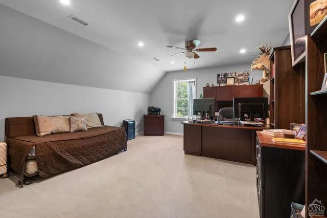 a living room with furniture gym equipment and a large window