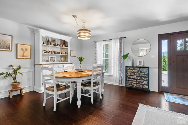 a view of a dining room with furniture wooden floor and chandelier