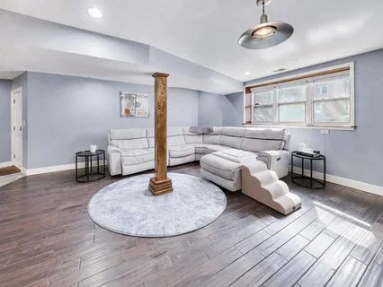 a living room with furniture and kitchen view