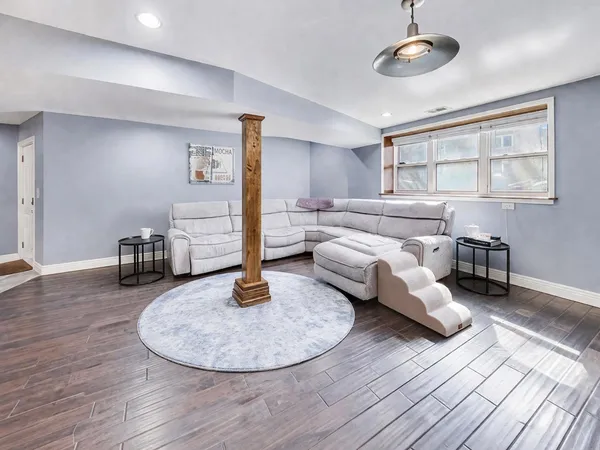 a living room with furniture and kitchen view