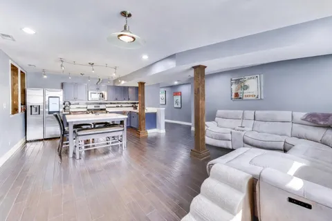 a kitchen with kitchen island a dining table and chairs
