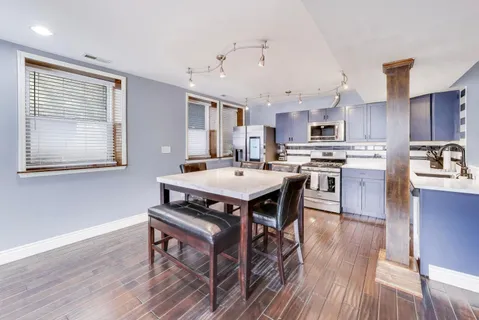 a kitchen with granite countertop a sink stove and cabinets