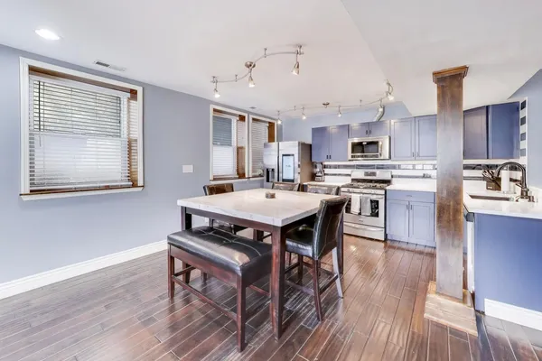 a kitchen with granite countertop a sink stove and cabinets