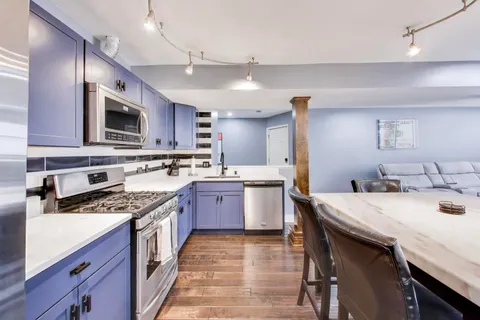a dining room with a wooden table and chairs