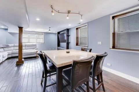 a bedroom with a bed and a flat tv screen on dresser