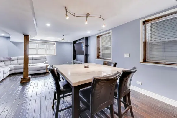a bedroom with a bed and a flat tv screen on dresser
