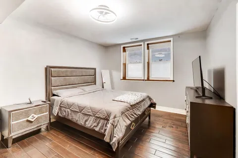 a bedroom with a bed and wooden floor