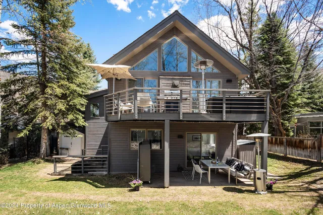 a view of a house with snow on the table and chairs