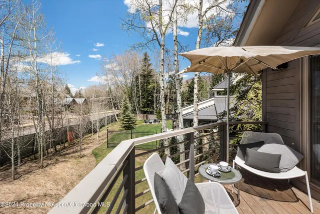 a balcony with table and chairs