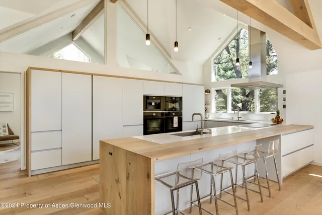 a kitchen with stainless steel appliances kitchen island granite countertop a refrigerator and a stove