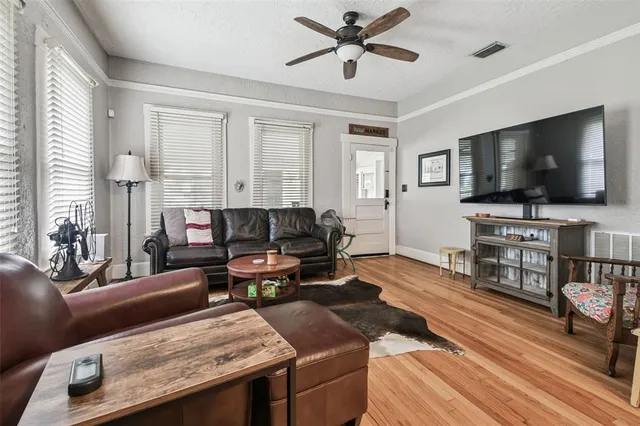 a living room with furniture and a dining table