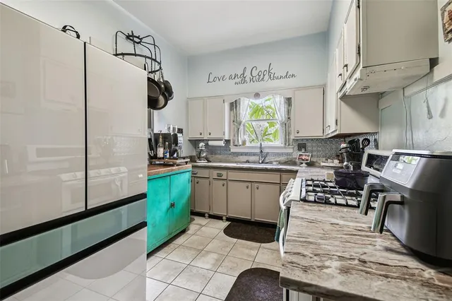 a bathroom with a granite countertop sink a toilet and a shower