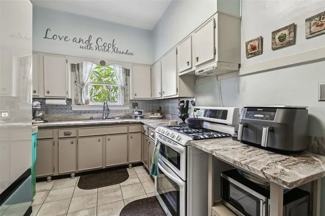 a bathroom with a granite countertop sink a toilet and mirror