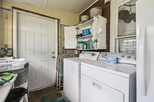 a living room filled with furniture hardwood floor and a floor to ceiling window