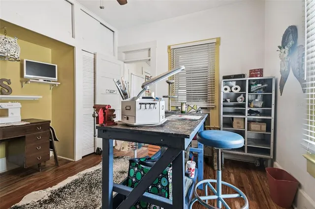 a view of house with a big yard and large trees