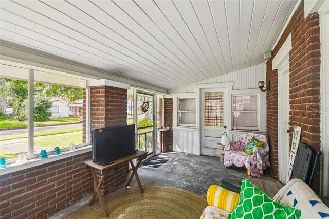 an aerial view of a city with lots of residential buildings and mountain view in back