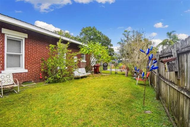 an aerial view of a house with a yard and trees