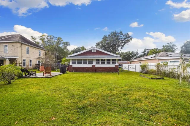 a view of a house with a big yard and sitting area