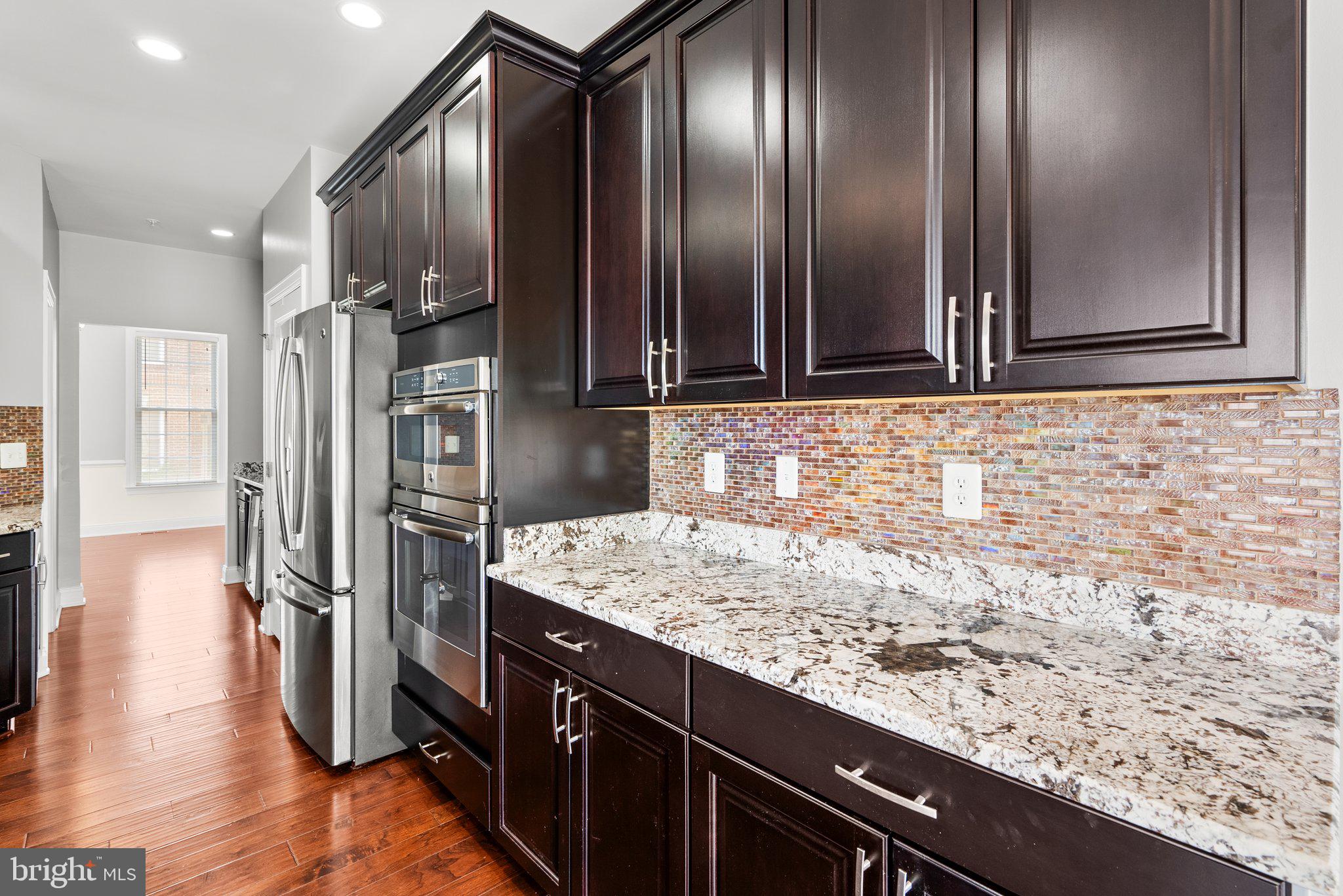 2501 Cherry Tree Road Hanover, MD 21076 - Photo 11 of 30 a kitchen with granite countertop stainless steel appliances and wooden cabinets