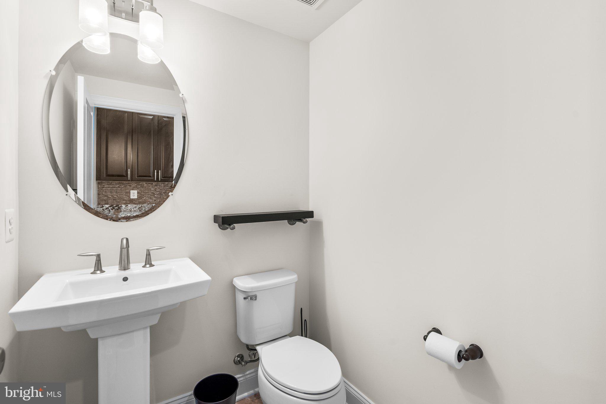 2501 Cherry Tree Road Hanover, MD 21076 - Photo 14 of 30 a bathroom with a toilet sink and mirror