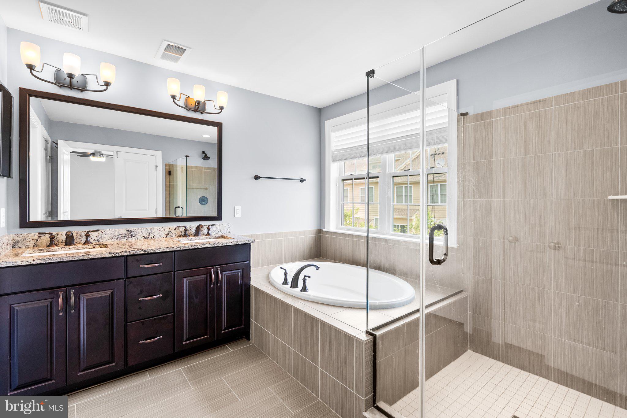 2501 Cherry Tree Road Hanover, MD 21076 - Photo 17 of 30 a bathroom with a tub sink and mirror