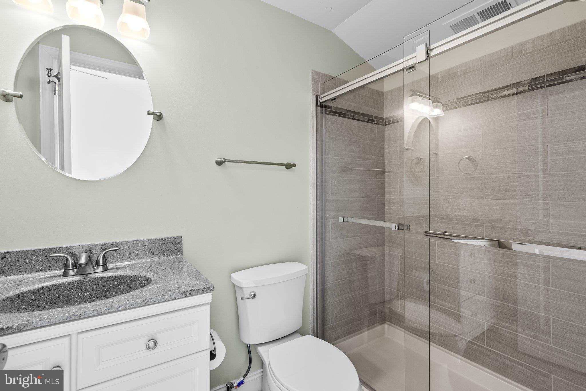 2501 Cherry Tree Road Hanover, MD 21076 - Photo 25 of 30 a bathroom with a granite countertop sink toilet a mirror and shower