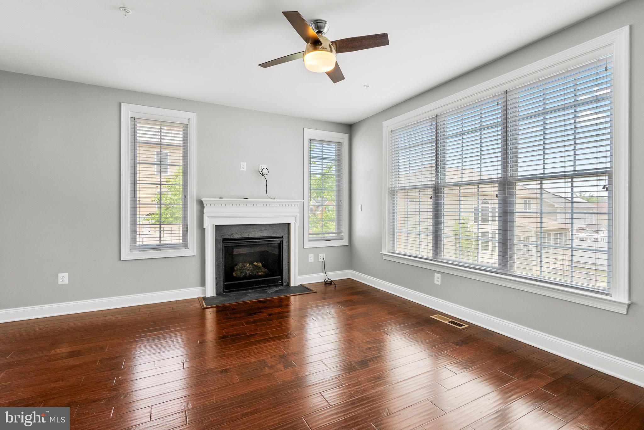 2501 Cherry Tree Road Hanover, MD 21076 - Photo 7 of 30 a living room with fireplace and wooden floor