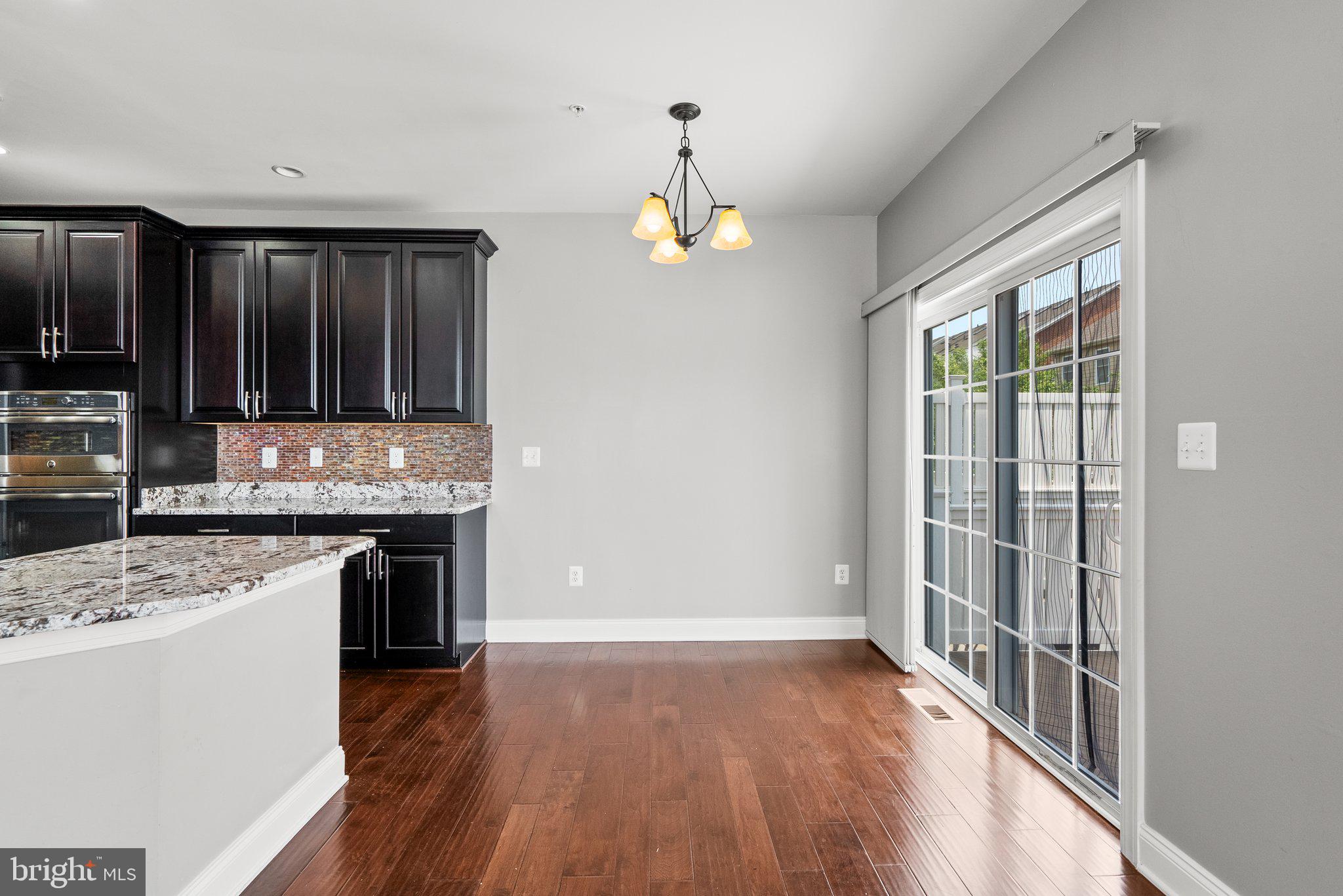 2501 Cherry Tree Road Hanover, MD 21076 - Photo 9 of 30 a view of kitchen with granite countertop stainless steel appliances and wooden floor